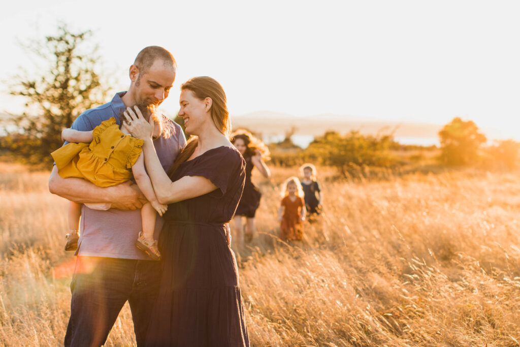 large family session at sunset embracing the chaos.