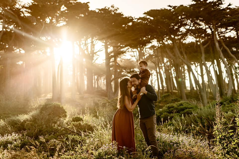 Photo of a family of 3 in a california forest at sunset by Ashley Kaplan Photography