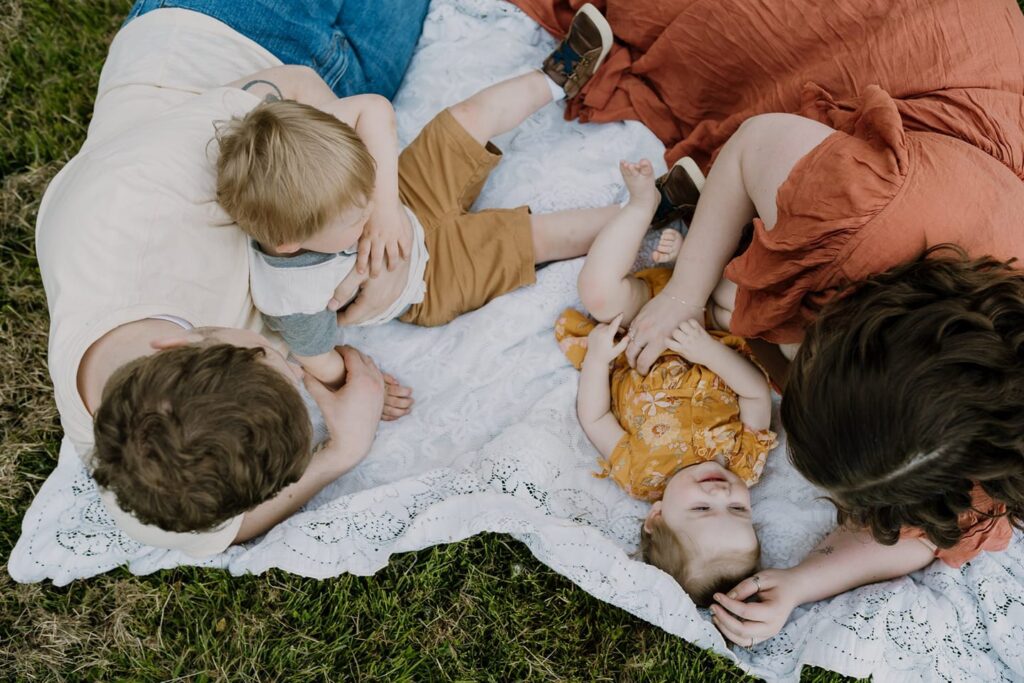 Photo of family from above cuddling on a blanket by Susannah Treadway Photography.