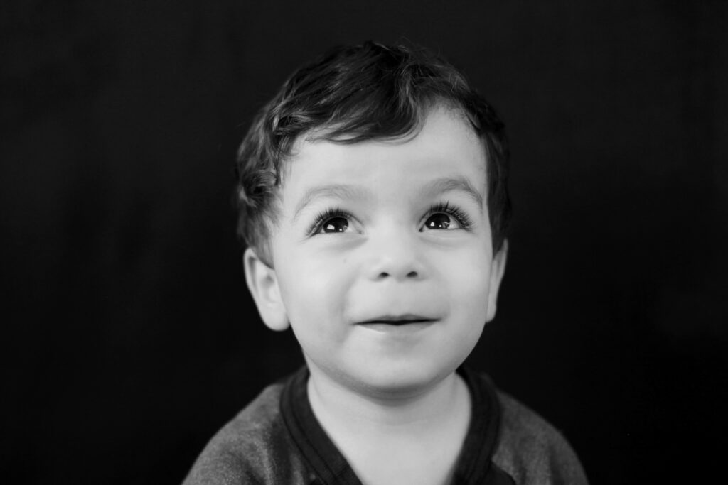 black and white portrait of a young boy, fine art school photo.