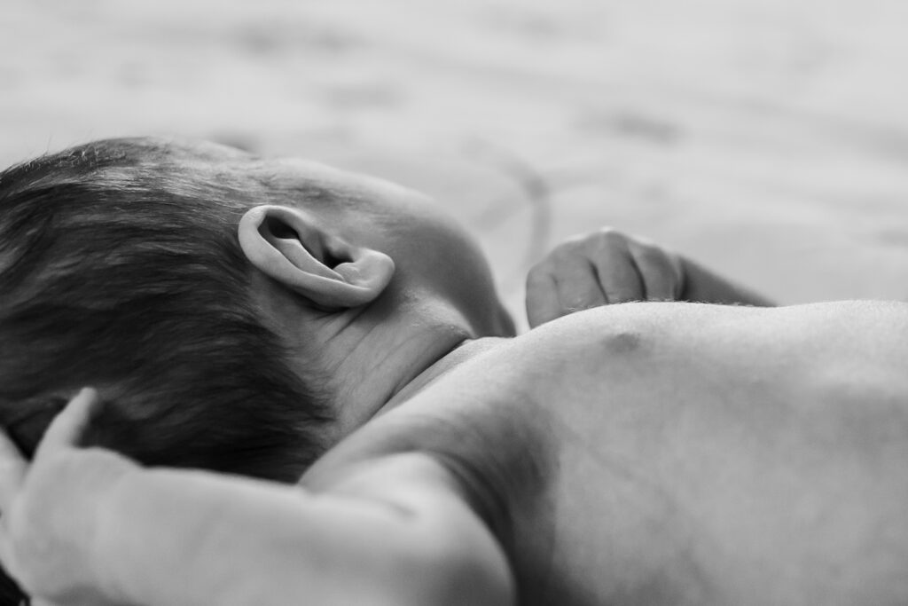 Up close detail photo of newborn baby ear.