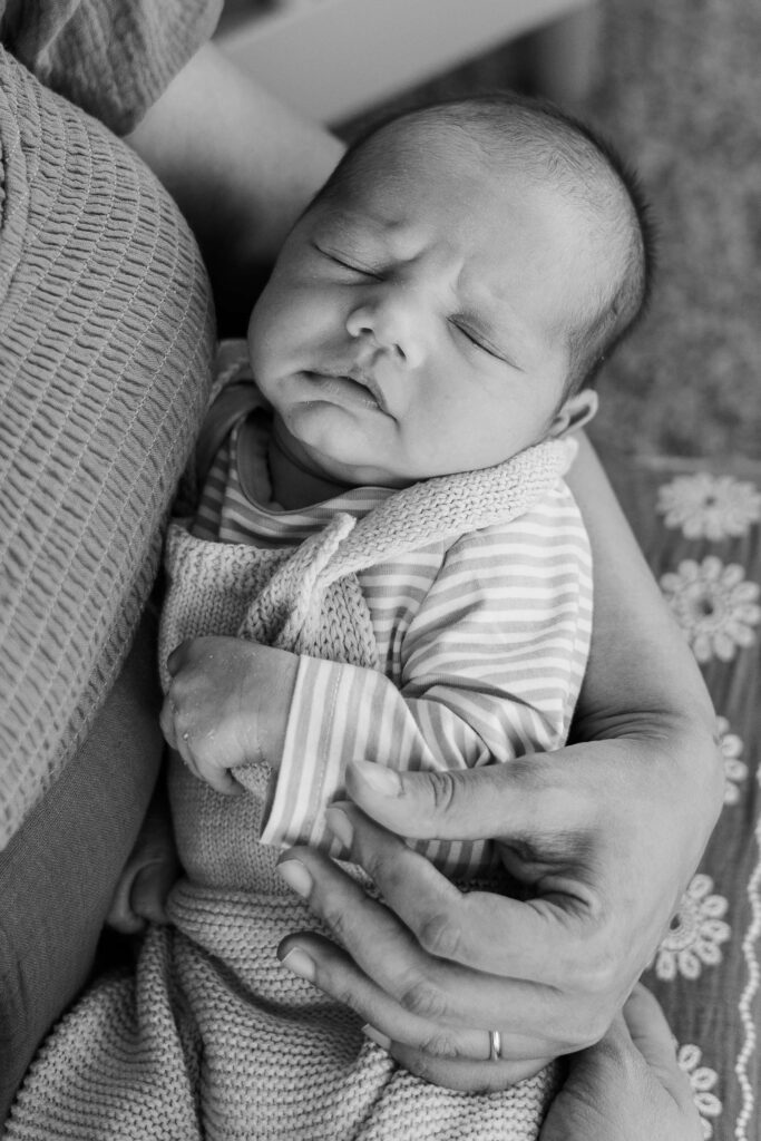 Newborn baby being held by mom.