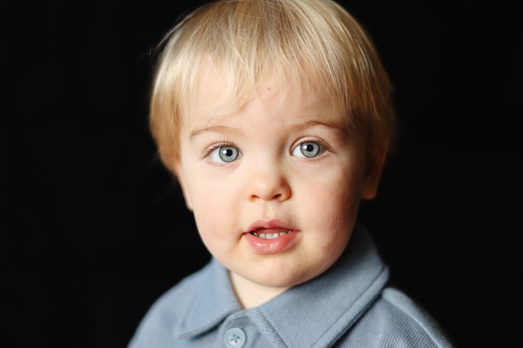 A simple one light school photography lighting setup featuring a Profoto flash and a large umbrella in a studio space.