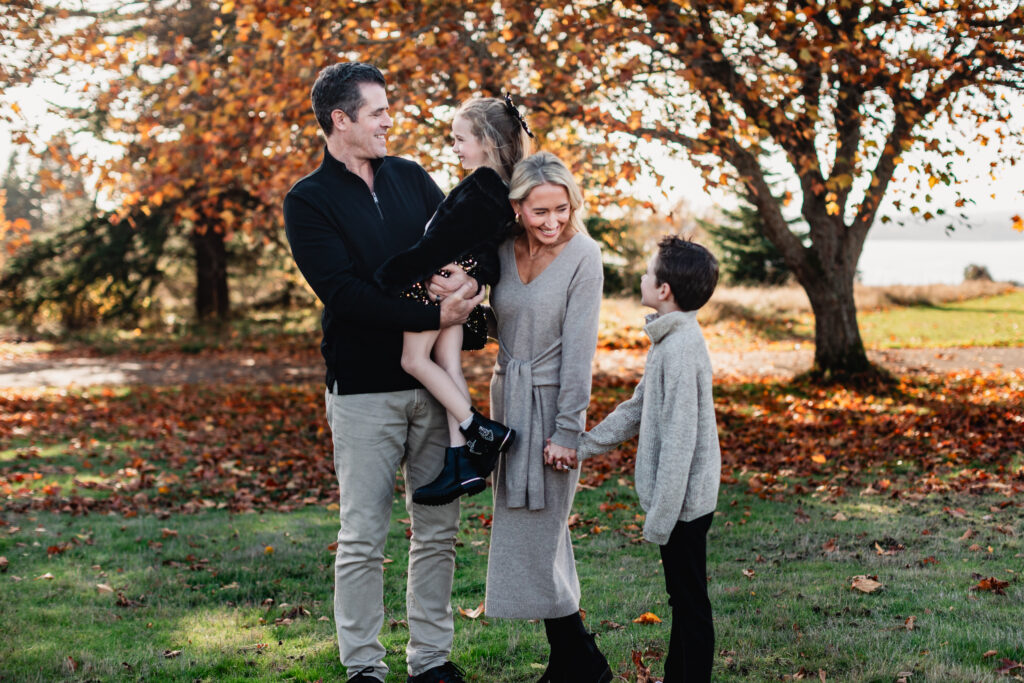 A candid family portrait highlighting how to pose families using physical connection and gentle direction.