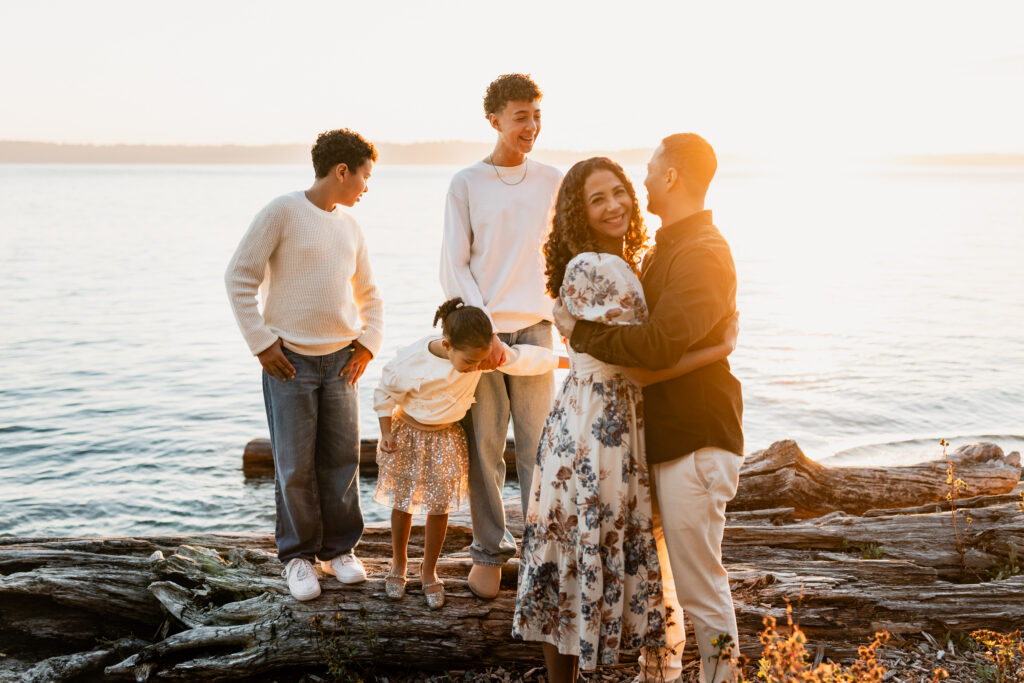 A large family of six walking together outside, demonstrating how movement helps when posing large families.