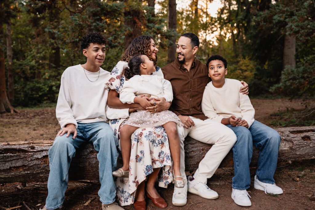 Lifestyle family photography showing a candid example of posing large families by layering kids around parents.