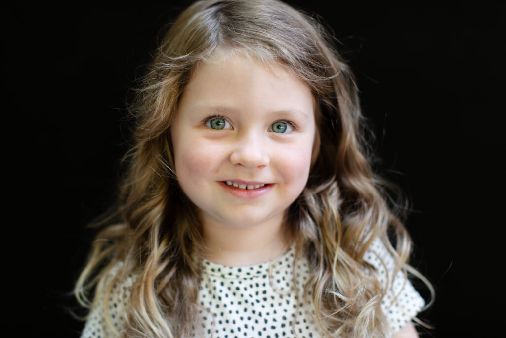 A simple, minimal portrait setup near window light illustrating how to start school photography with simple gear.